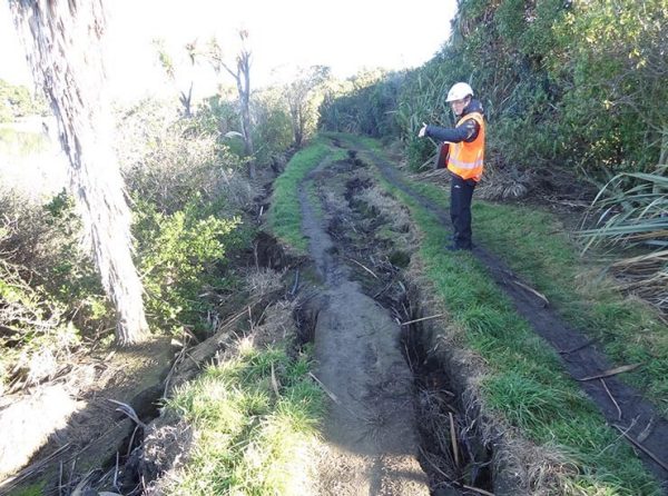 Gareth Cowles surveying earthquake damage on a slope       