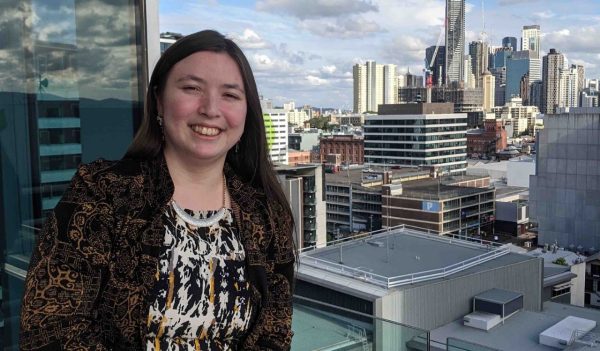 Ella Hingston with city skyline in the background.