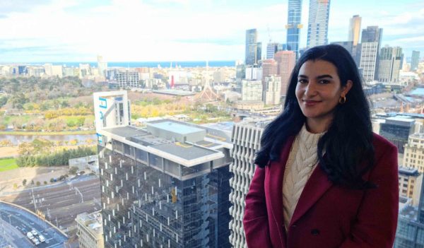 Lara Al-Assany with city skyline in the background.