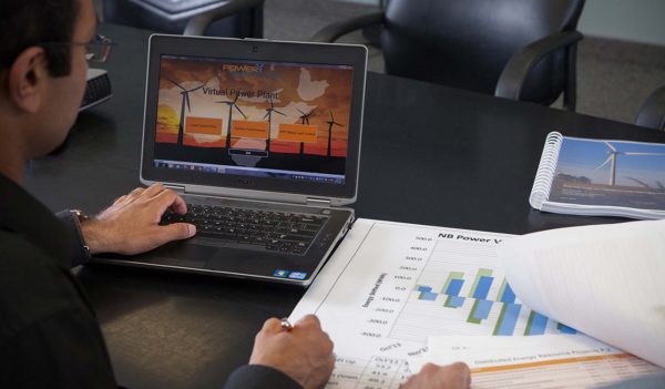 Stock image man working on laptop with drawings on the desk