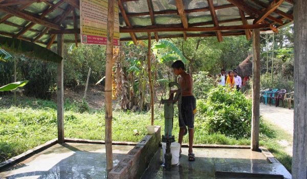 A boy getting water from a tap