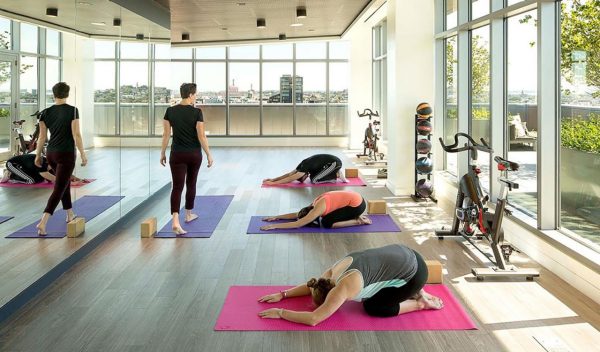 Exercise room with people doing yoga