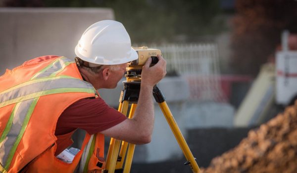 surveyor in PPE on construction site