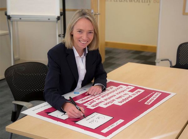 Cath Schefer signs a pledge