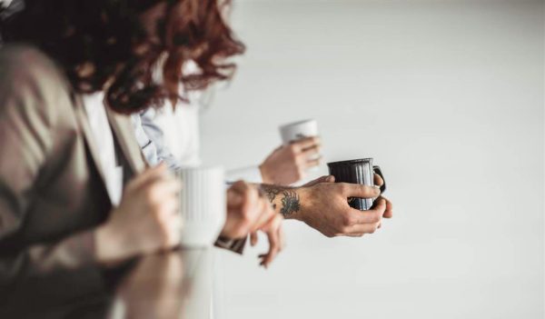 hands holding cups