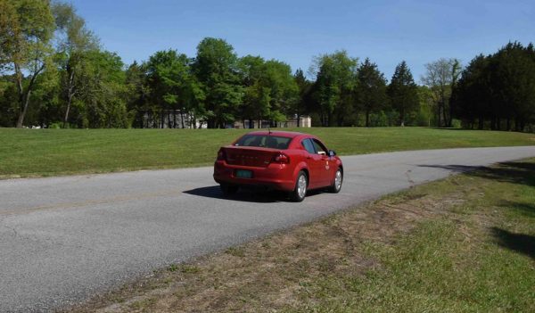 red car driving on the road