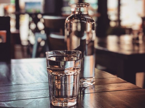 water glass and bottle on counter