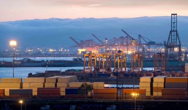 Industrial Harbor with cranes and cargo containers.