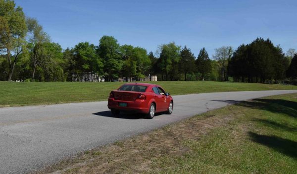 red car driving on the road