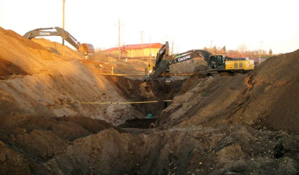 Backhoe digging in a trench