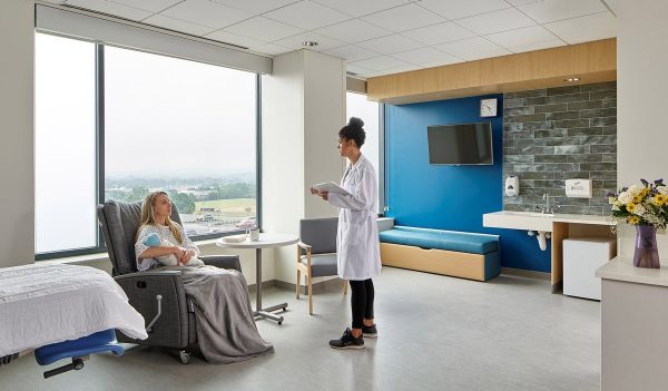 A nurse and new mom with baby in a hospital room