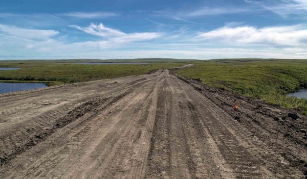 dirt road, green land, blue sky