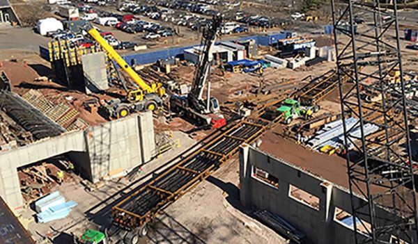 The 90-foot risers are delivered to the project site.