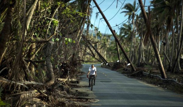 Man riding bike with power lines down