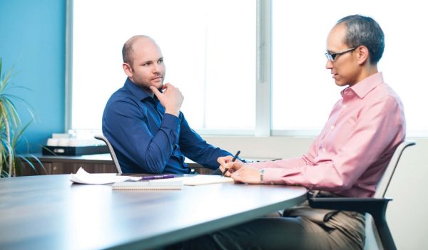 two guys at table talking