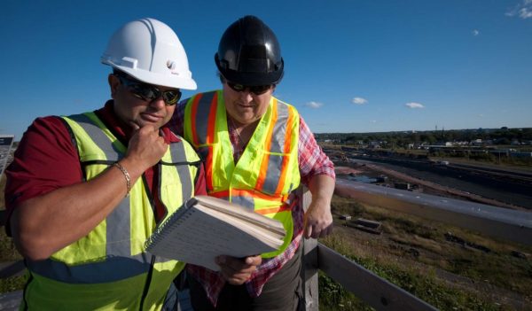 two workers review notes