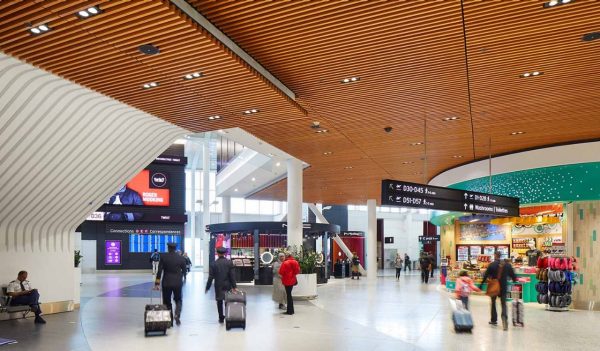 People moving about the airport with shops