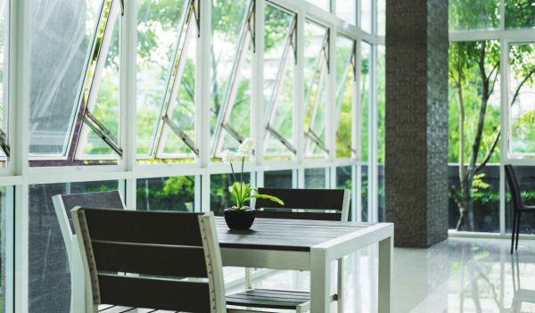 Modern interior lobby living space, with window and table with chairs