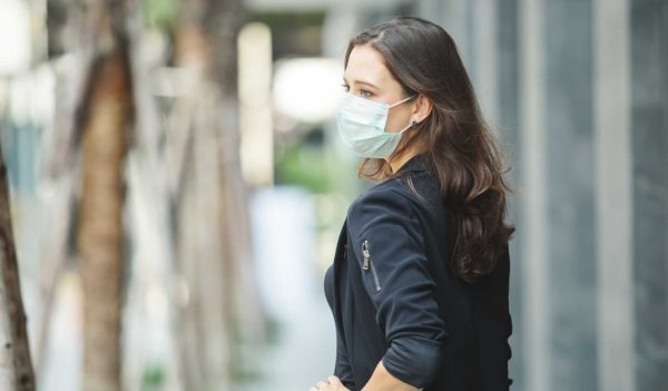 close up face woman wearing medical mask prevent infection virus in coronavirus covid 19 pandemic, copy space.