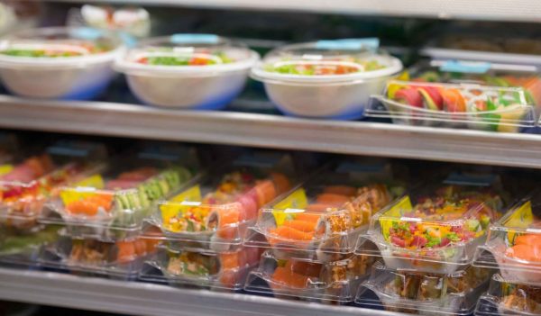 Fresh sushi for sale at a supermarket deli in togo containers