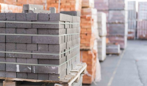 Construction Materials. Building materials for construction of residential complex. Pile of white bricks at construction site.