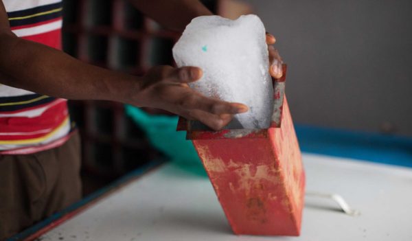 Hands holding a block of ice