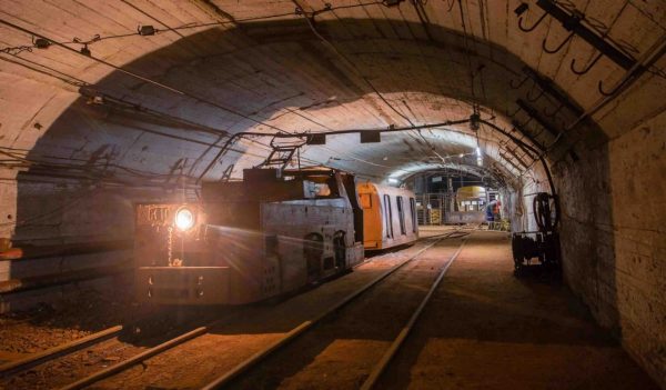 Underground gold bauxite mine shaft tunnel with electric locomotive