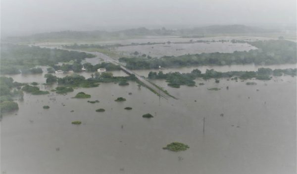 Aerial view of a large flooded land mass during a storm.