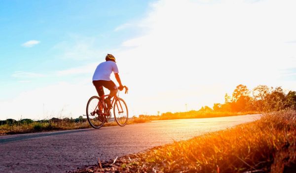 Silhouette of cyclist in motion on the background of beautiful sunset,ride bicycle on sunset background,Silhouette of man ride a bike in sunset background.