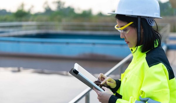 Female environmental engineer working at wastewater treatment plants,Water supply engineering working at Water recycling plant for reuse