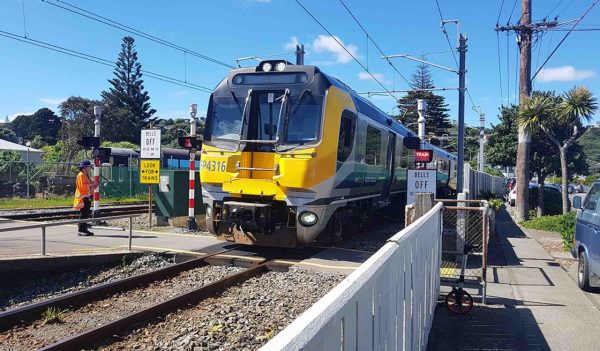 Person conducting a safety assessment at light rail level crossing.