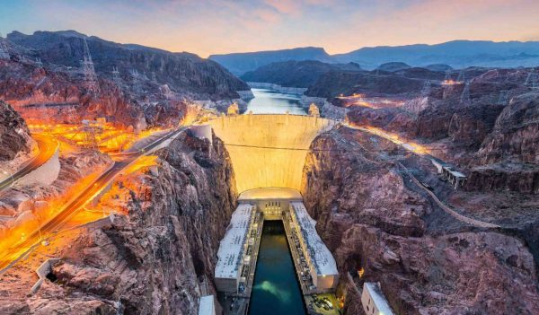 Hooover Dam on the Colorado River straddling Nevada and Arizona at dawn.