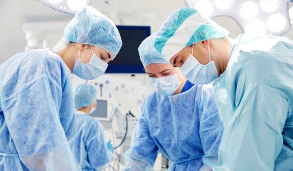 Group of surgeons in operating room at hospital