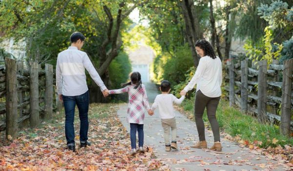 Image of Elisa and her family walking down a path.