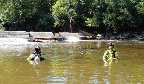 Mussel divers in a river