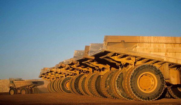 Ore hauling trucks in row, Telfer, Western Australia