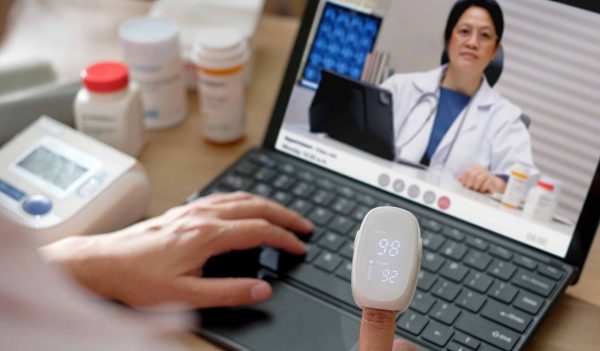 asian woman telemedicine doctor online visit with computer at home