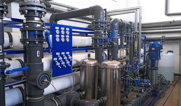 inside room of wastewater treatment facility with pipes and many manometer indicators, sensors, sampler and rotameters, water filtration factory