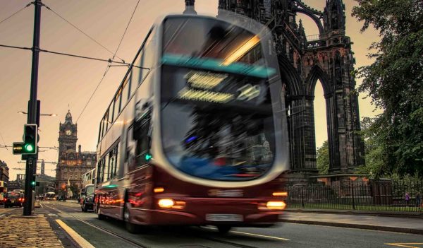 Bus driving on street in  Edinburgh.