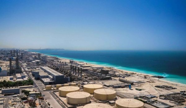 Aerial view of a desalination plant along the coastline.