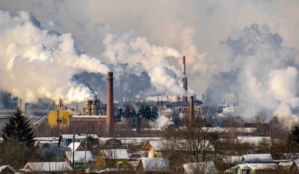 Industrial area with chimneys and smog over the city.