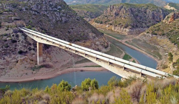 Pipeline bridge over a river in the mountains.