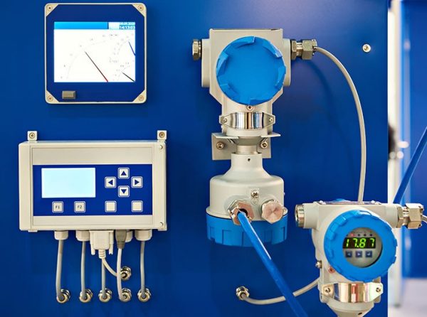 Electronic digital pressure gauge and water flow calculation equipment at an industrial exhibition