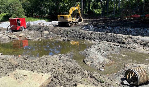 Backhoe on site removing mud