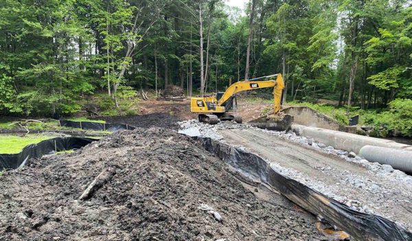 Backhoe on site moving mud