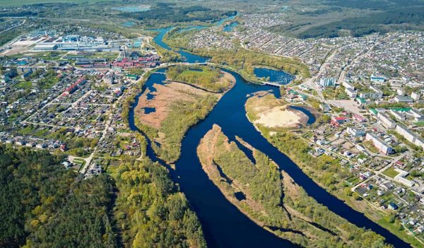 Aerial view of river floodplan and green forest