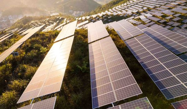 Rows of solar panels on a hill.