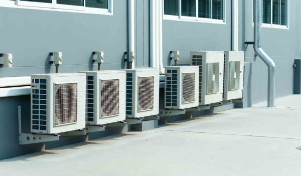 Air conditioner compressor units on the side of a building.