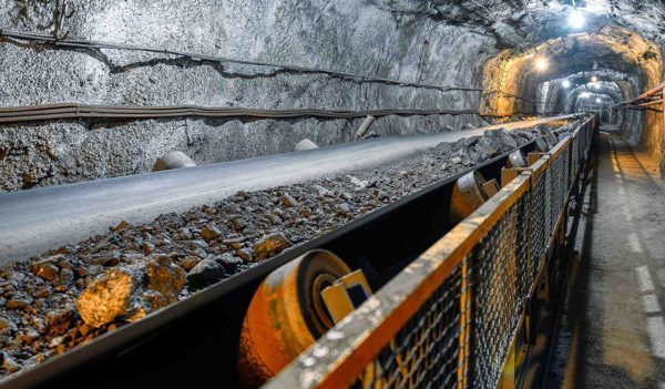 Belt conveyor in an underground tunnel. Transportation of ore to the surface.