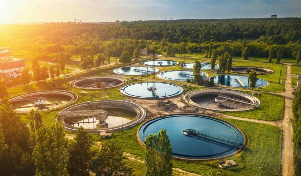 Aerial view of modern industrial sewage treatment plant at sunset.